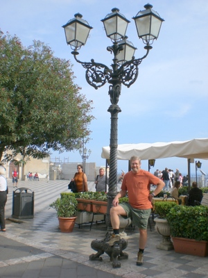 Dennis, holding a lamp post down.